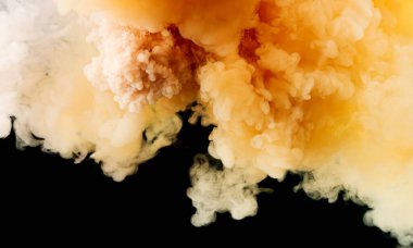 Background of falling white and yellow paint in water