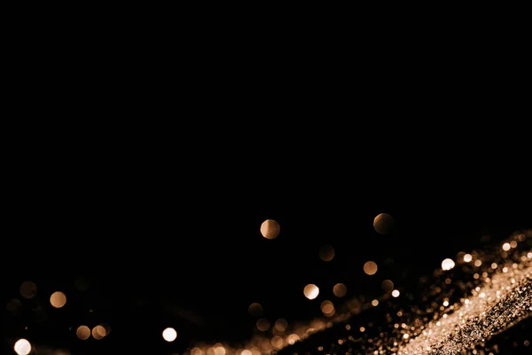 Gold color sparkle roll down on black background — Stock Photo, Image
