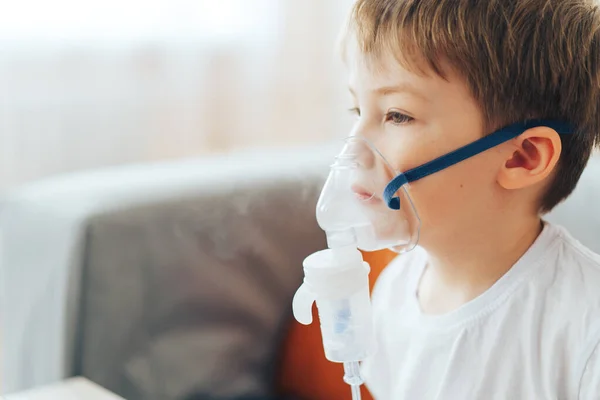 Menino usando máscara de nebulizador respira remédio para asma — Fotografia de Stock