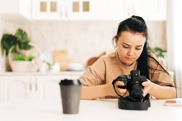 Girl Adjusts Camera Sitting White Table — Stok fotoğraf
