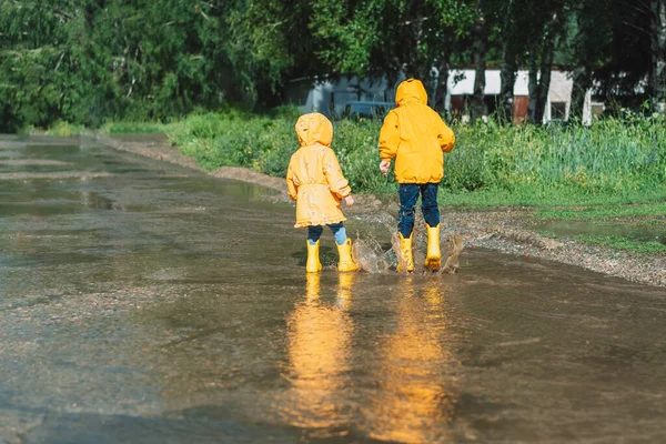 Children Yellow Rubber Boots Walk Puddles — Foto Stock
