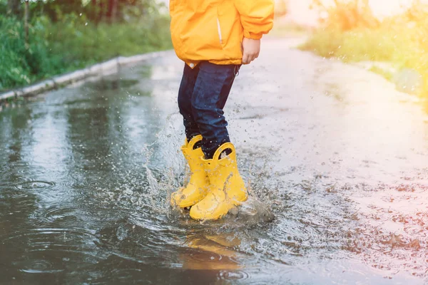 Child Yellow Rubber Boots Jumping Puddles — Foto Stock