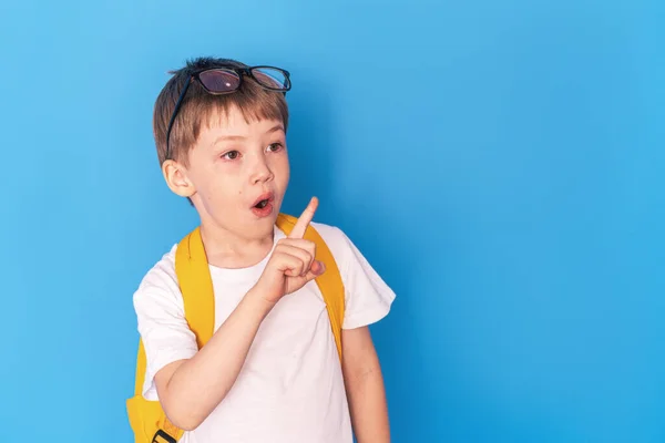 Surprised Boy Eyeglasses Yellow Briefcase Stands Blue Background — Stok fotoğraf