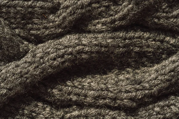 Background of gray knitted woolen thread close-up.