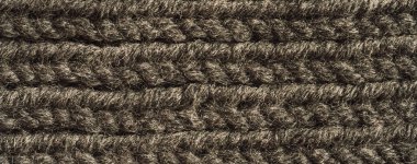 Gri örülmüş yün ipliğin arka planı.