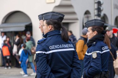 Landerneau, France - April 03 2022: Group of gendarmes surveilling the crowd during the carnival of Landerneau. clipart