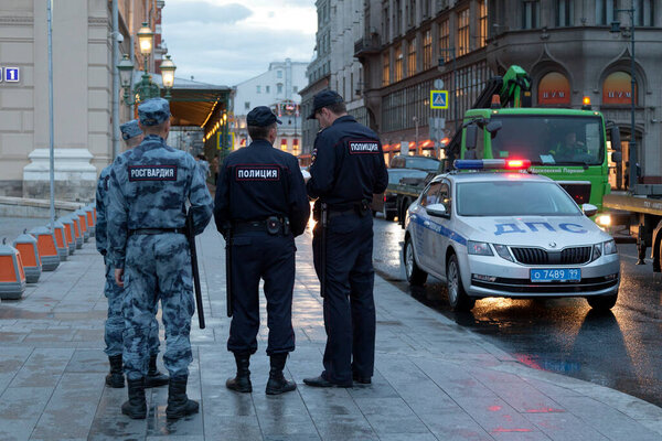 Moscow, Russia - July 07 2018: Two policemen and two officers of the Rosgvardia at Theater Square oposite the Bolshoi.