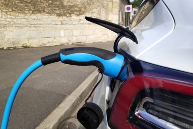 Electric car being recharge at a charging station.