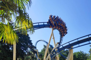 Plailly, France - August 10 2022: OzIris is a steel inverted roller coaster located in Parc Asterix, a theme park in France based on the comic book series Asterix by Albert Uderzo and Rene Goscinny.