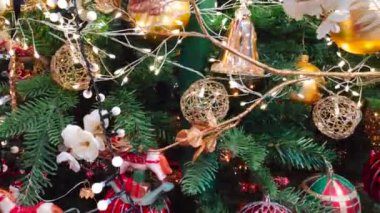 Christmas decorations hanging from a Christmas tree spinning on itself.