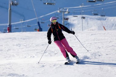 Pas de la Casa, Andorra, December 07 2019: Woman Skiing on the ski slope of Grandvalira, the largest ski resort in the Pyrenees and southern Europe. clipart