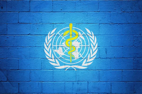 Flag of the World Health Organization painted on a brick wall.
