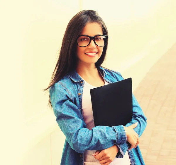 Portret Uśmiechniętej Młodej Kobiety Noszącej Okulary Folderem Mieście — Zdjęcie stockowe