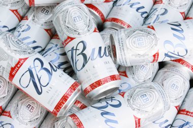 KHARKIV, UKRAINE - 1 Ağustos 2021: Birçok konserve Budweiser Alkol Birası gri arka planda yatar. Budweiser, Anheuser-Busch Inbev 'den Amerika' nın en popüler markasıdır.