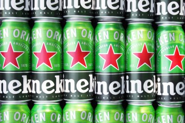 KHARKIV, UKRAINE - 1 Ağustos 2021: Birçok Heineken alkollü birası gri arka planda yatar. Heineken, Hollanda 'nın en büyük ve dünyanın en büyük ikinci bira şirketidir..