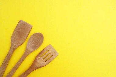 Parlak sarı bir zemin üzerinde bir dizi bambu tabağı. Yemek pişirme konsepti.