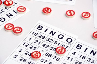 Masa başı bingo ya da loto oynamak için arka planda numaraları ve kartları olan bir sürü tahta fiş. Rus Lotosu 'nun dünya çapında klasik bingo oyunlarına benzer kuralları vardır..