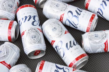 KHARKIV, UKRAINE - 1 Ağustos 2021: Birçok konserve Budweiser Alkol Birası gri arka planda yatar. Budweiser, Anheuser-Busch Inbev 'den Amerika' nın en popüler markasıdır.