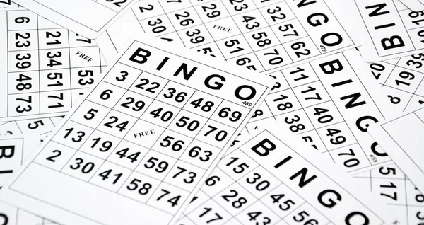 A lot of cards for a board game of bingo or lotto on a light background. Russian Lotto has the same rules as the classic worldwide bingo game.