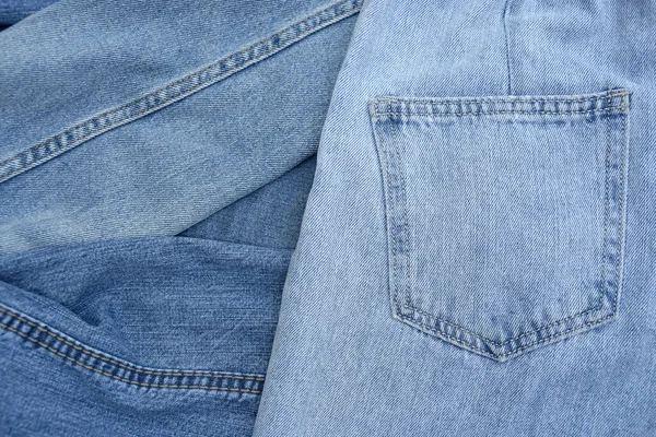 Sporo Spodni Dżinsów Stercie Jeansowe Tło Koncepcja Zakupu Sprzedaży Zakupów — Zdjęcie stockowe