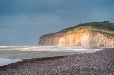Steep chalk cliffs of Hautot sur Mer in Normandy, France in a stormy summer weather.