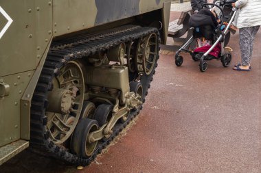 Arromanches, France - August 2, 2021: Old american military vehicle in Normandy and a children stroller