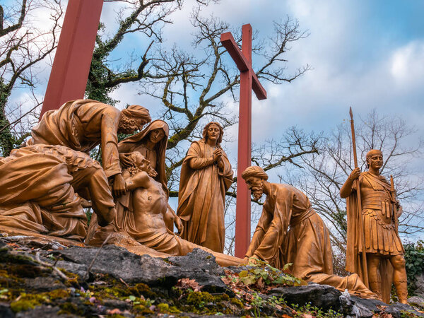 Lourdes, France - January 5, 2022: Way of the cross of Lourdes - thirteenth station: Jesus is taken down from the cross