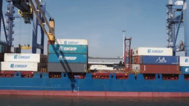 Rotterdam, Netherlands - April 28, 2022: Unloading containership in the port of Rotterdam, one of the largest seaports in the world and the largest deep-water port in Europe