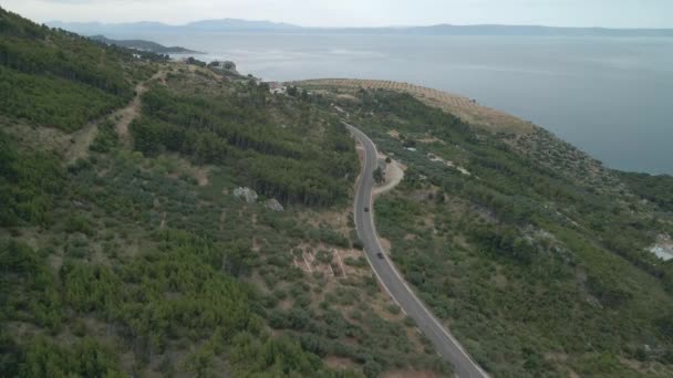 Drone vista de una carretera de montaña en la región de Makarska Riviera en Croacia con una impresionante costa adriática y en el fondo. — Vídeo de stock