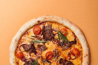 Dana filetosu, kiraz domatesli mavi soğan, gouda peynirli mozzarella peyniri. Bej arka plan. Boşluğu kopyala