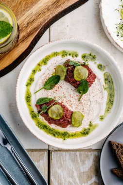 Yer mantarı soslu dana tartar ve salatalık turşusu. en üstteki görünüm
