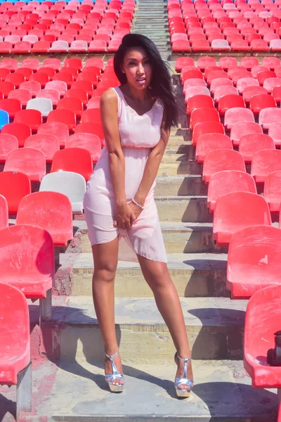 Asian Model Posing at the stadium standing on the bright seats — Stock Photo, Image