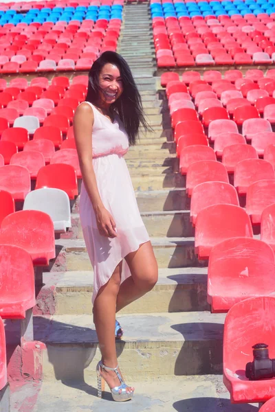 Asian Model Posing at the stadium standing on the bright seats — Stock Photo, Image