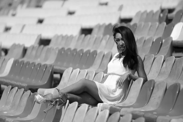 Asian model posing at the stadium sitting on bright seats — Stock Photo, Image