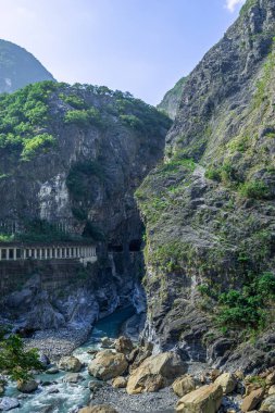 Beautiful natural scenic of the mountain rock with the river and walkway for sightseeing. (Shakadang river, Swallow Grotto, Yanzikou, Taroko, Hualien, Taiwan.)