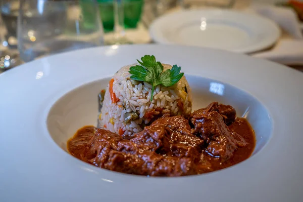 Meat with rice. Homemade beef served with rice on white plate at restaurant.