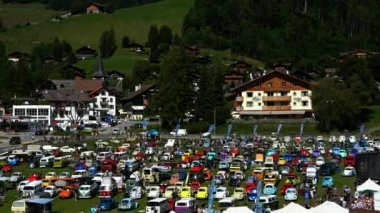 Chateau-d Oex, Switzerland - August 28, 2022: international vintage VW meeting. Volkswagen beetle. Canton of Vaud, Switzerland. Time lapse of people in exposition.