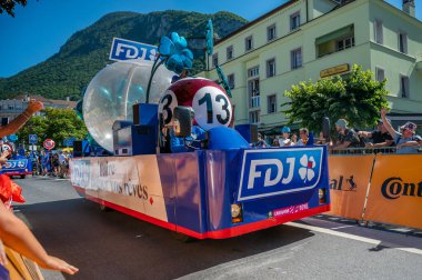 Aigle, Valais Canton, Switzerland -July 10, 2022: Passage of an advertising car of Groupama FDJ in the caravan of the Tour de France in Switzerland. People.