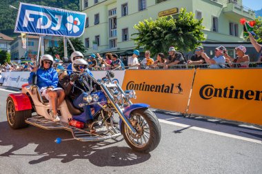 Aigle, Valais Canton, Switzerland -July 10, 2022: Passage of an advertising car of Groupama FDJ in the caravan of the Tour de France in Switzerland. People.