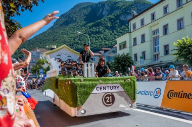 Aigle, Valais Canton, Switzerland -10 July, 2022: Passage of an advertising car of Century 21 brand real estate company in the caravan of the Tour de France in Switzerland. Sport event.