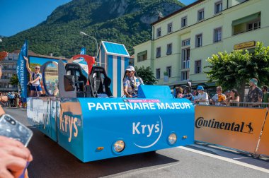Aigle, Valais Canton, Switzerland -10 July, 2022: Passage of an advertising car of Krys audition group in the caravan of the Tour de France in Switzerland.