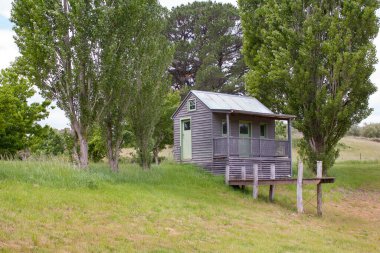 Daylesford, Victoria / Avustralya - 1 Kasım 2014: Lavandula lavanta çiftliğinde ağaçlar ve doğa ile çevrili davetkar ve büyüleyici küçük bir ev. İzole edilmiş küçük ev konsepti.