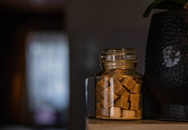 Turuncu oda lambasında kavanozda kahverengi şeker küpleri