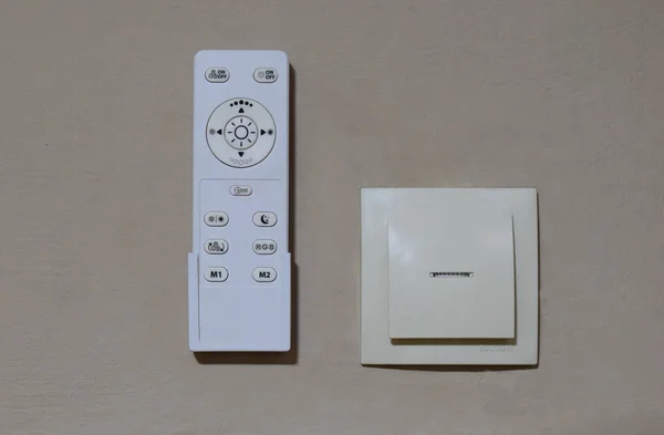 Household lighting control panel and standard wall switch.