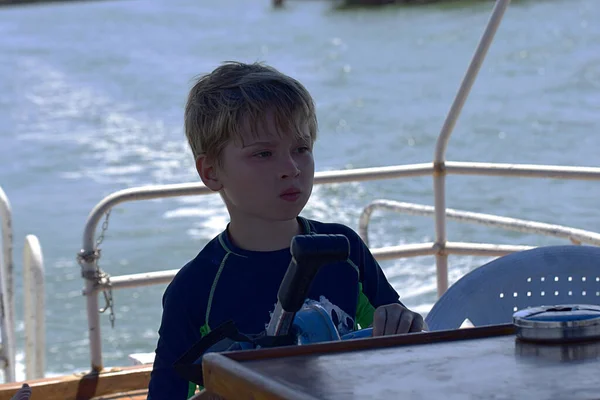 Boy Concentrated Look Drives Ship Large River — Stock Photo, Image