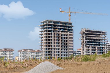Construction of new residential buildings on the background of a residential area in Turkey.