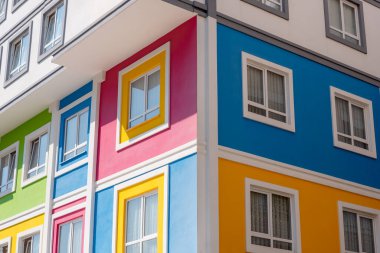 Fragment of the corner of a bright multi-colored kindergarten building.