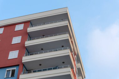 Modern ventilated facade with balconies. Fragment of a new elite residential building or commercial complex. Part of city real estate.