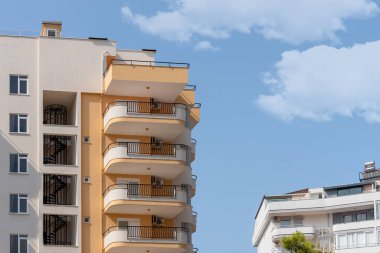 Architectural elements on the facade of a residential building - windows, balconies, a fire escape. Copy space.