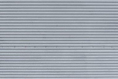 Fence made of corrugated board made of galvanized iron. Texture background.